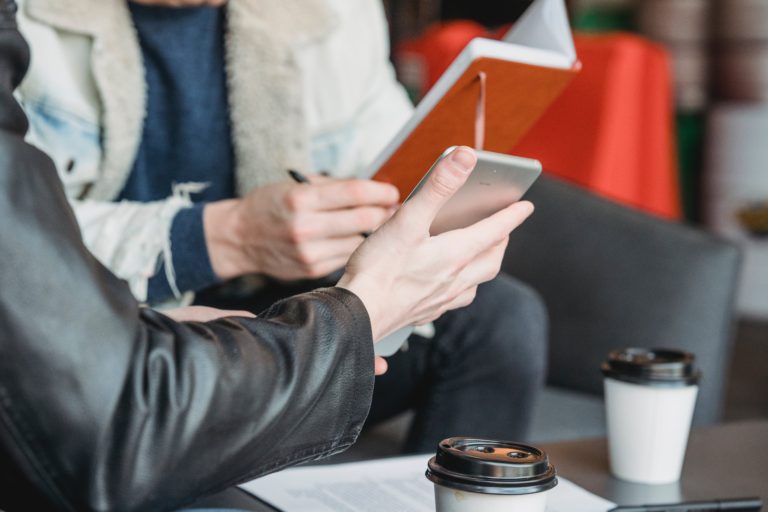 Digital Marketing consulting services. Two people having a business meeting at a coffee shop.